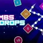 Texto Bombs Drops con varios bloques de colores y números en un fondo azul oscuro