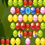 Frutas y caramelos de colores brillantes, incluyendo fresas, limones y esferas en una cuadrícula sobre un fondo verde