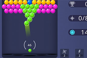 Pantalla de un juego con esferas de colores que se agrupan mientras se dispara una esfera verde desde la parte inferior