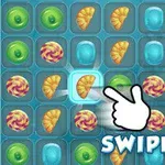 Interfaz de juego de rompecabezas con piezas de caramelo y una mano señalando un croissant, acompañado de la palabra SWIPE