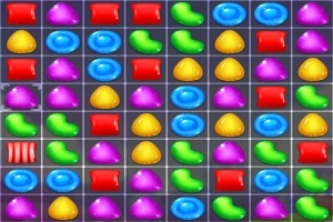 Caramelos de colores en una cuadrícula, incluyendo formas como frijoles verdes, gotas azules, y triángulos amarillos