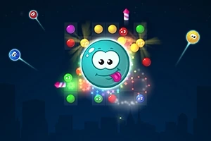 Personaje azul sonriente con lengua afuera rodeado de luces y bolas de colores sobre un fondo oscuro