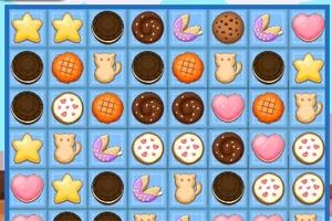 Galletas de diferentes formas y colores (estrellas, corazones, gatos, círculos) dispuestas en un tablero de fondo azul