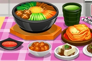Tazón de sopa con verduras y champiñones, acompañado de té verde, tofu, kimchi y albóndigas sobre un mantel a cuadros rosas