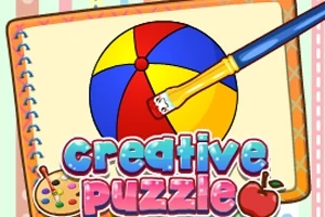 Un cuaderno con una ilustración de una pelota de playa multicolor y un pincel junto a los textos creative puzzle