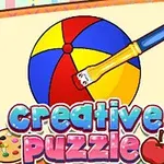 Un cuaderno con una ilustración de una pelota de playa multicolor y un pincel junto a los textos creative puzzle