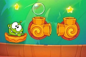 Una criatura verde con grandes ojos se encuentra en una plataforma junto a dos cañones naranjas y dos estrellas brillantes sobre un fondo verde