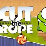 Un personaje verde con grandes ojos mirando un caramelo colgante frente a un fondo con el texto Cut the Rope