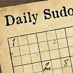 Un tablero de sudoku parcialmente completado con un bolígrafo y una pluma junto a él