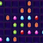 Una cuadrícula oscura con casillas que contienen esferas brillantes de varios colores como verde, naranja, rosa, azul y rojo