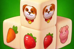 Cubos con ilustraciones de un perro, una zanahoria, una fresa y un cerdo sobre un fondo verde