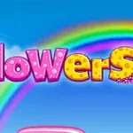 La imagen muestra la palabra flowers en letras coloridas con un diseño de flores y un arcoíris en el fondo sobre un cielo azul