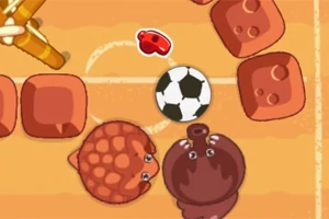 Dos animales animados y una pelota de fútbol en un campo color arena rodeado de bloques marrones