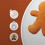 Galleta de jengibre en forma de muñeco sobre un fondo dividido en marrón y blanco, con íconos de decoración a la izquierda