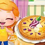 Niña animada guiñando un ojo junto a un pastel decorado con crema y frutas en una cocina colorida