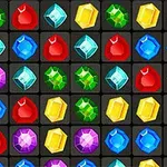 Grupo de gemas de colores brillantes dispuestas en una cuadrícula sobre un fondo oscuro