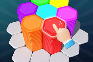 Mano señalando un bloque hexagonal rojo brillante sobre una pila de bloques de colores