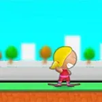 Niño rubio en patineta sobre un camino con fondo de árboles y edificios