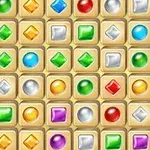 Una cuadrícula llena de joyas de colores con formas variadas sobre un fondo beige