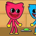 Dos personajes caricaturescos, uno rosa y otro azul, de pie junto a un botón verde sobre el suelo