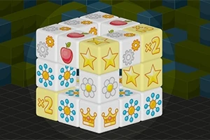Cubo tridimensional con imágenes de estrellas, coronas, flores y manzanas sobre un fondo de cuadrícula con tonos verdes y azules