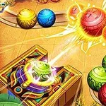 Bolas de colores brillantes en movimiento en un tablero con un cañón decorado en una esquina