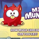 Un personaje rojo con orejas puntiagudas y grandes ojos está sentado al lado de la frase MINI MUNCHER, junto a un bloque de chocolate