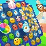 Tablero de juego con fichas coloridas de caras de animales y elementos brillantes sobre un fondo campestre