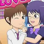 Pareja de personajes de estilo animado sentados frente a una computadora con un letrero de LOVE arriba