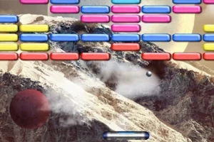 Bloques de colores y una bola frente a un paisaje montañoso de fondo