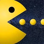 Figura amarilla en forma de círculo con boca abierta, frente a tres esferas en un fondo estrellado