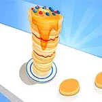 Torre de hotcakes con miel y chispas de colores en una superficie blanca con un fondo azul