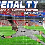 Portero en uniforme gris intentando detener un penal mientras un jugador con uniforme blanco patea el balón hacia la portería en un estadio
