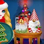 Niña con sombrero de Navidad y plato con galleta en forma de árbol frente a decoración navideña