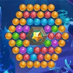 Conjunto de esferas de colores dispuestas en un patrón circular con una gema de color ámbar en el centro, sobre un fondo submarino