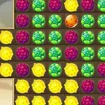 Rejillas con frutas coloridas en grupos de colores verde, morado y amarillo en un patrón de juego de combinación