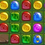 Mosaico de caramelos de colores brillantes en una cuadrícula sobre un fondo verde