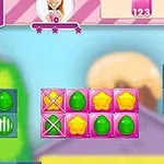 Interfaz de juego con formas de dulces de colores brillantes y corazones en la pantalla