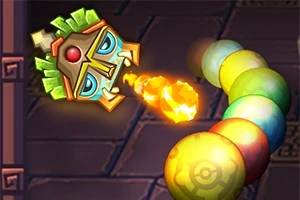 Una figura de máscara decorativa lanza una bola de fuego hacia una fila de esferas coloridas