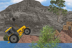 Tractor amarillo subiendo una pendiente rocosa cerca de un lago, con montañas y árboles al fondo