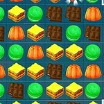 Cuadrícula colorida de dulces y postres con gomitas verdes, chocolates, gelatinas naranjas y pasteles amarillos en un patrón repetitivo